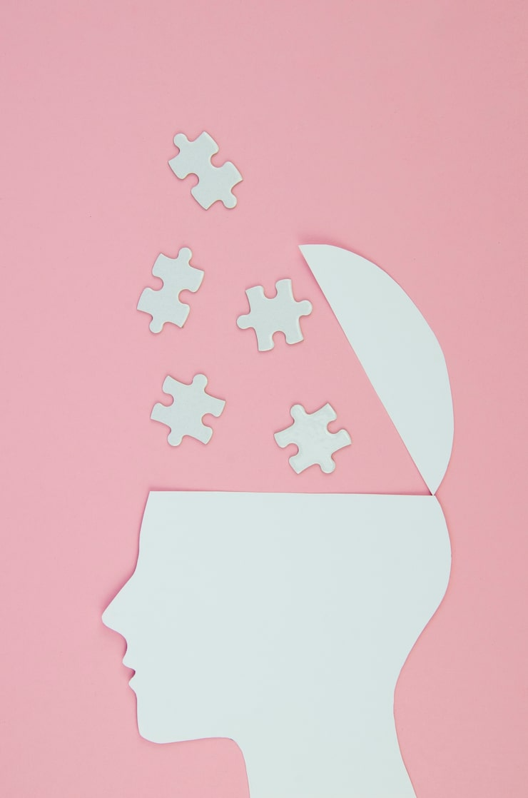 A paper cutout of a head with puzzle pieces-Bridge Health (Bipolar Disorder)