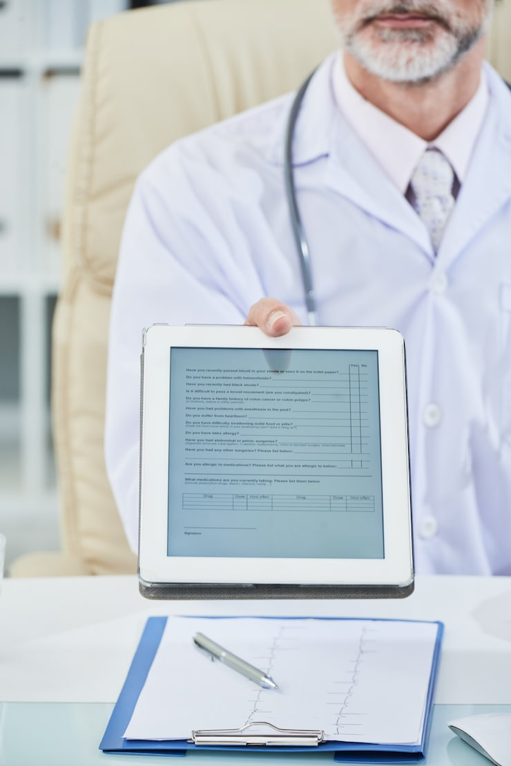 Doctor holding tablet with form-Bridge Health