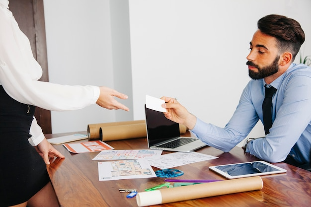 Two people exchanging cards-Bridge Health