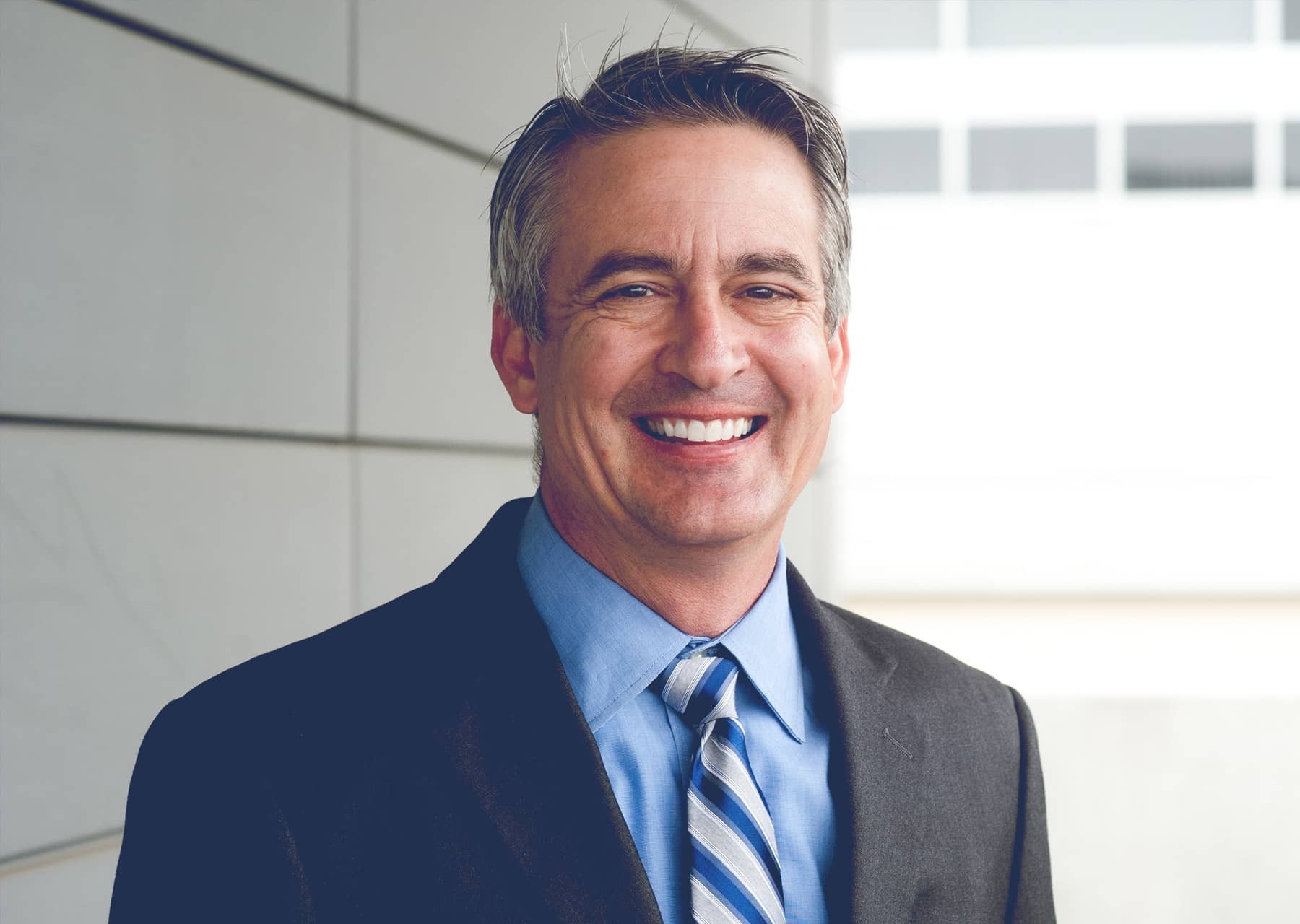 Smiling man in a suit-Bridge Health