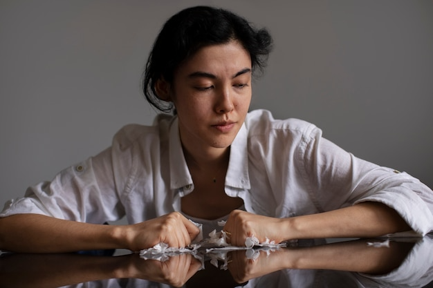 Woman clenching crumpled paper-Bridge Health (substance use disorder)